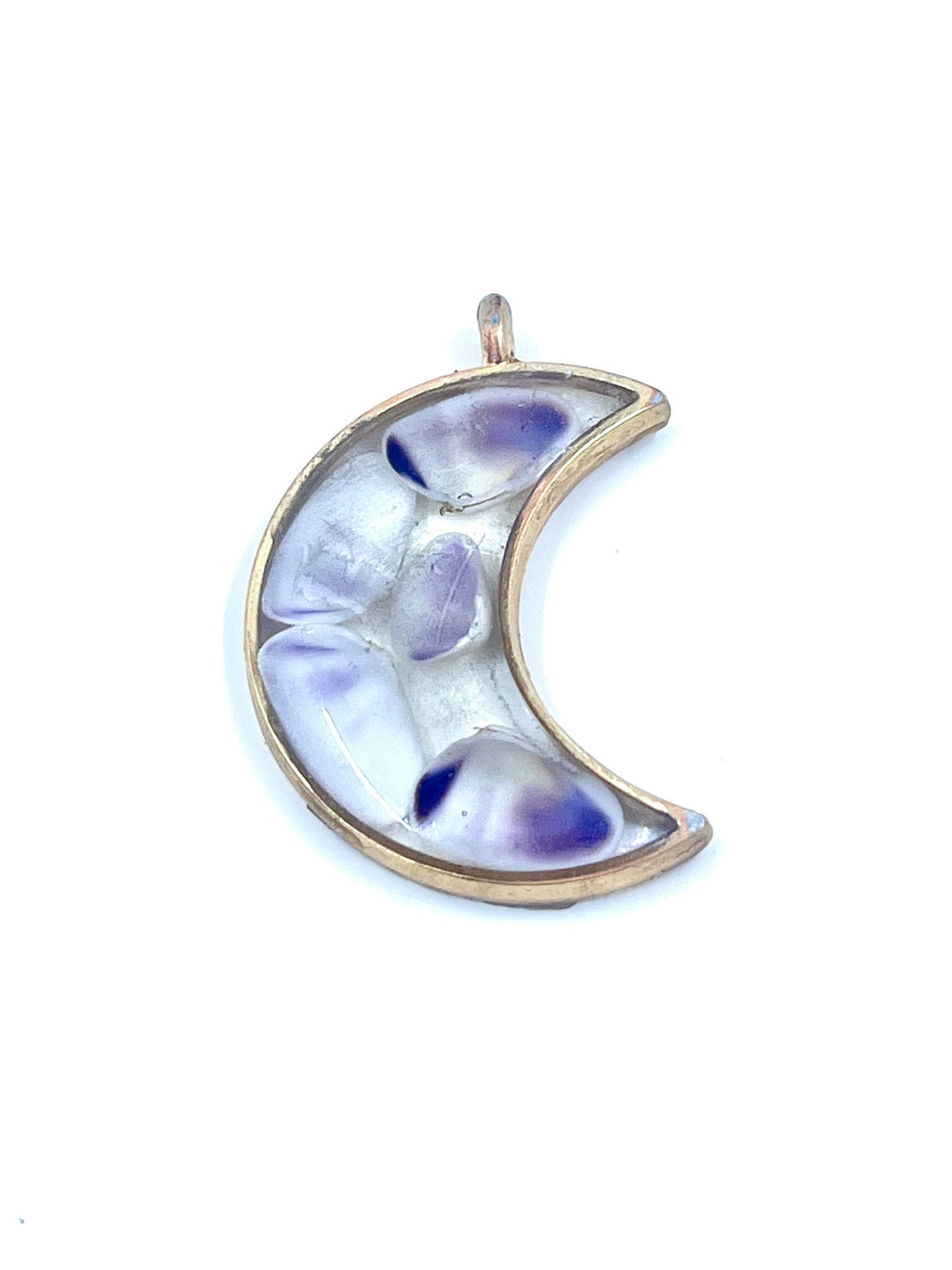 Crescent moon-shaped pendant with a floral design on a white background