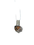 Necklace with a textured stone pendant on a white background