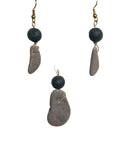 Pair of earrings with stone-like beads on a white background