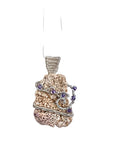 Pendant with natural shelland purple beads on a white background