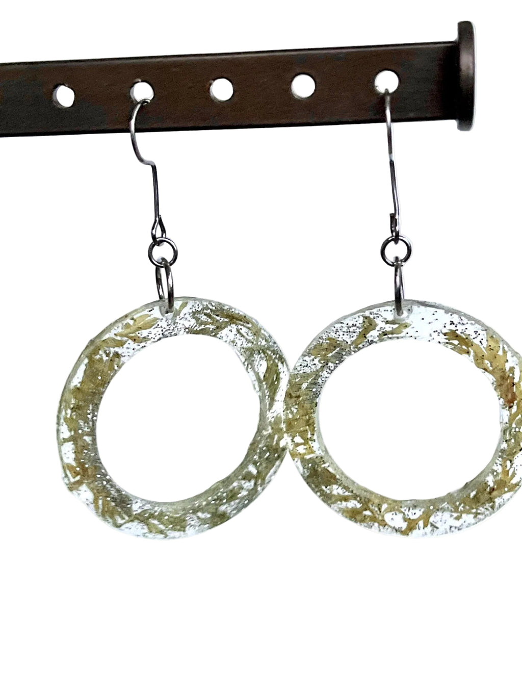 Handmade resin hoop earrings with real carrot leaves and silver sparkle suspended inside clear resin