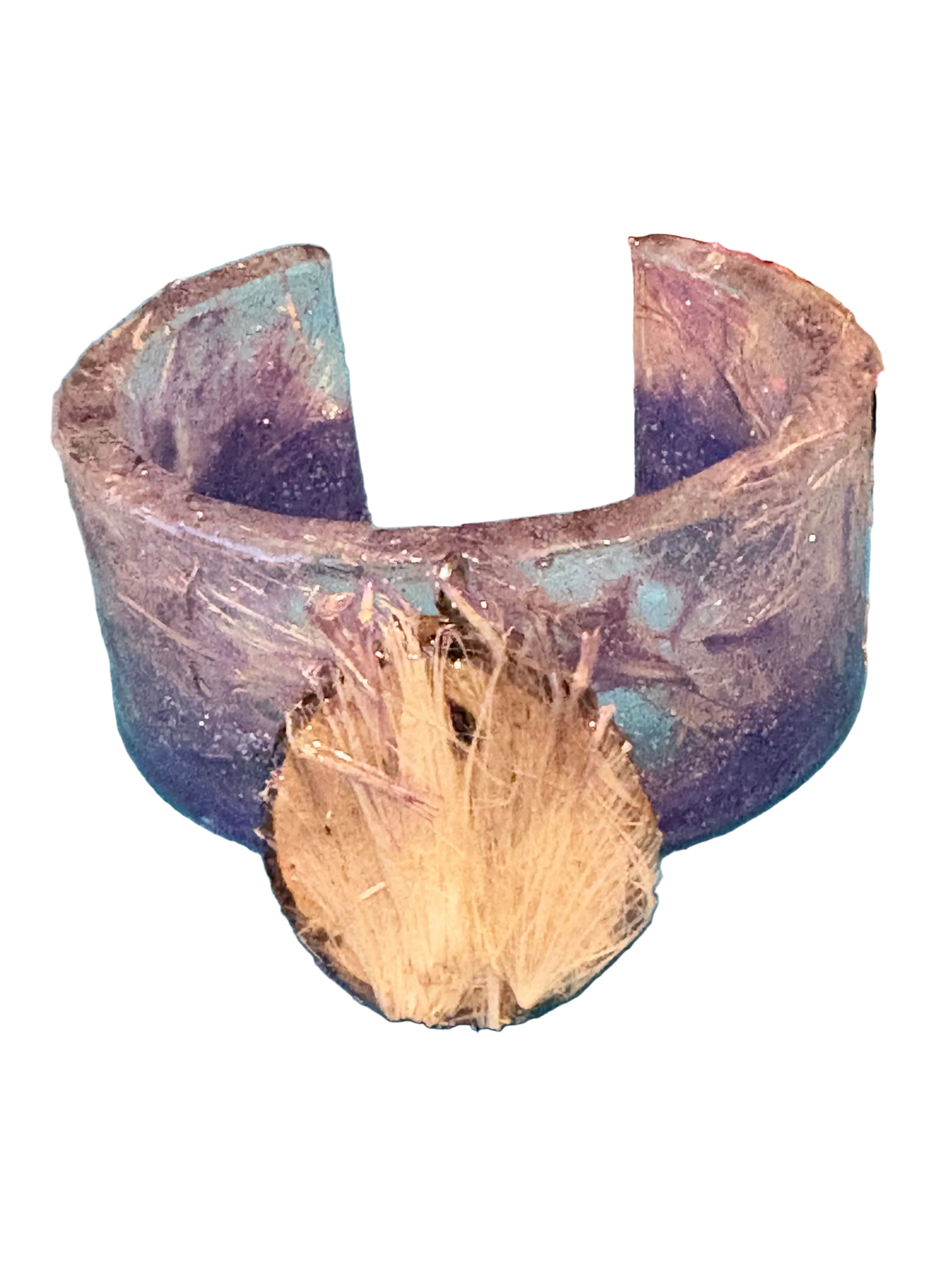 Wood slice pendant  leaned against resin bracelet, all with thistle florets.