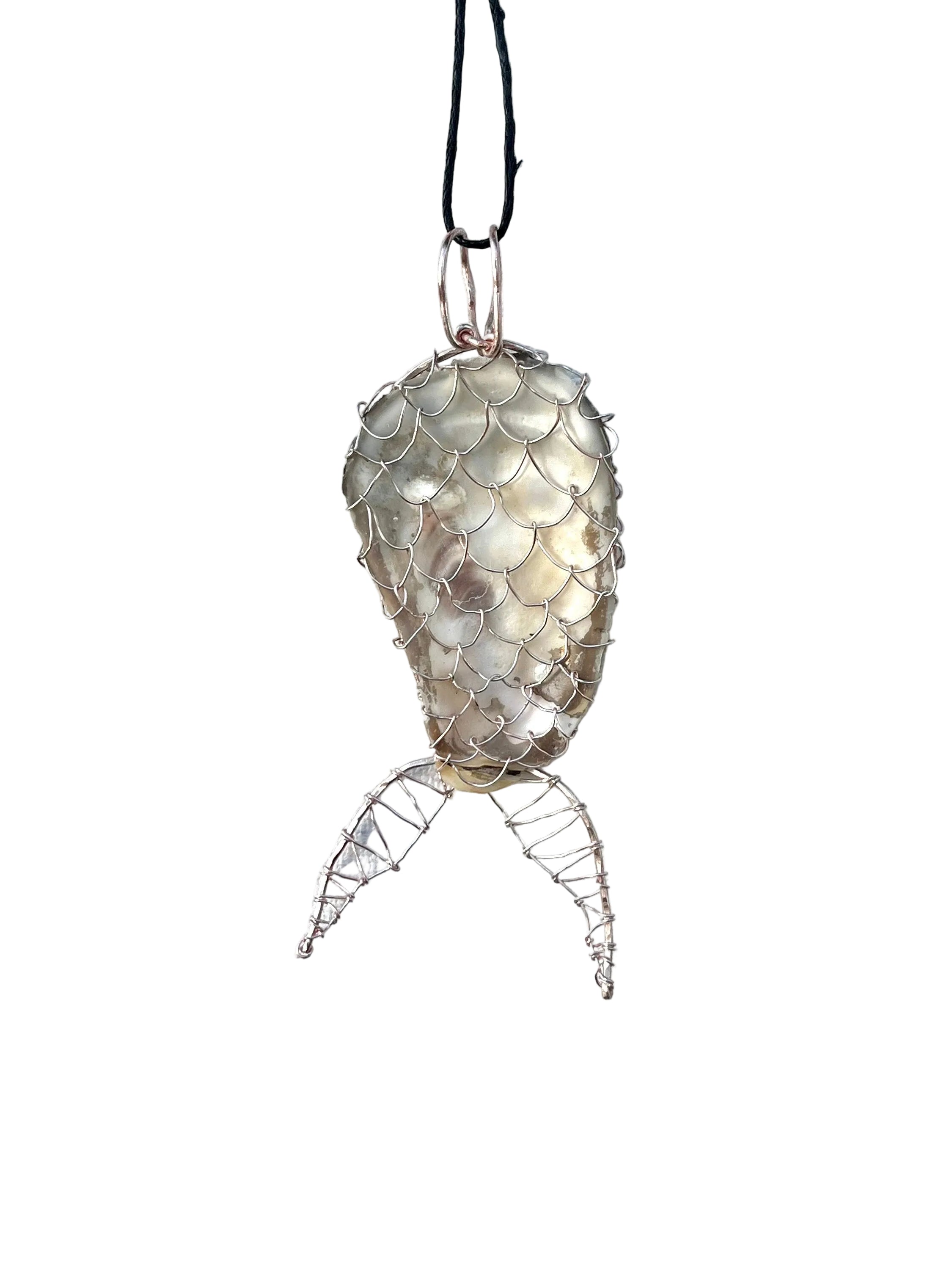 Decorative fish-shaped ornament with shell-like texture on a white background
