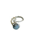 Silver ring with a blue stone on a white background