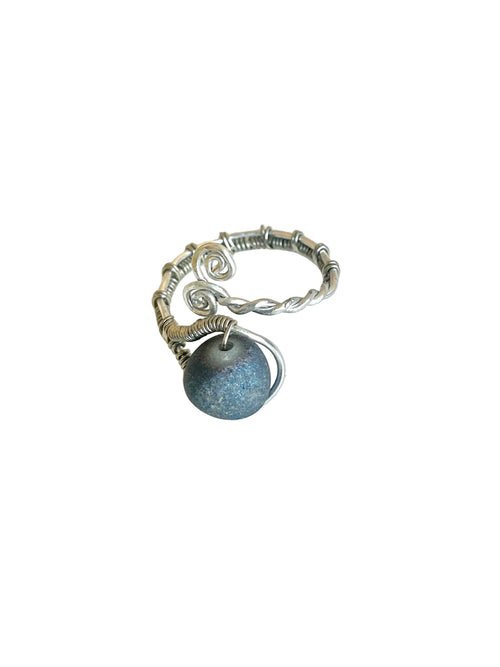 Silver ring with a blue stone on a white background