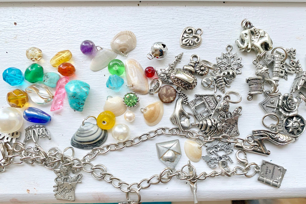 Collection of various charms and beads on a white surface