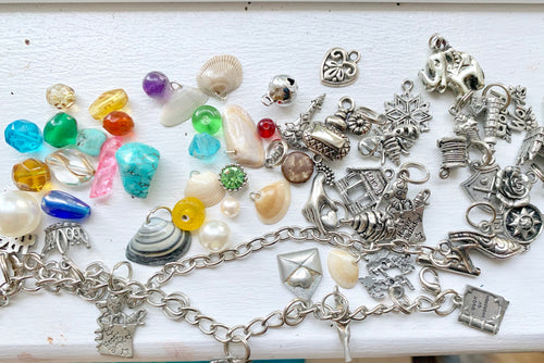 Collection of various charms and beads on a white surface