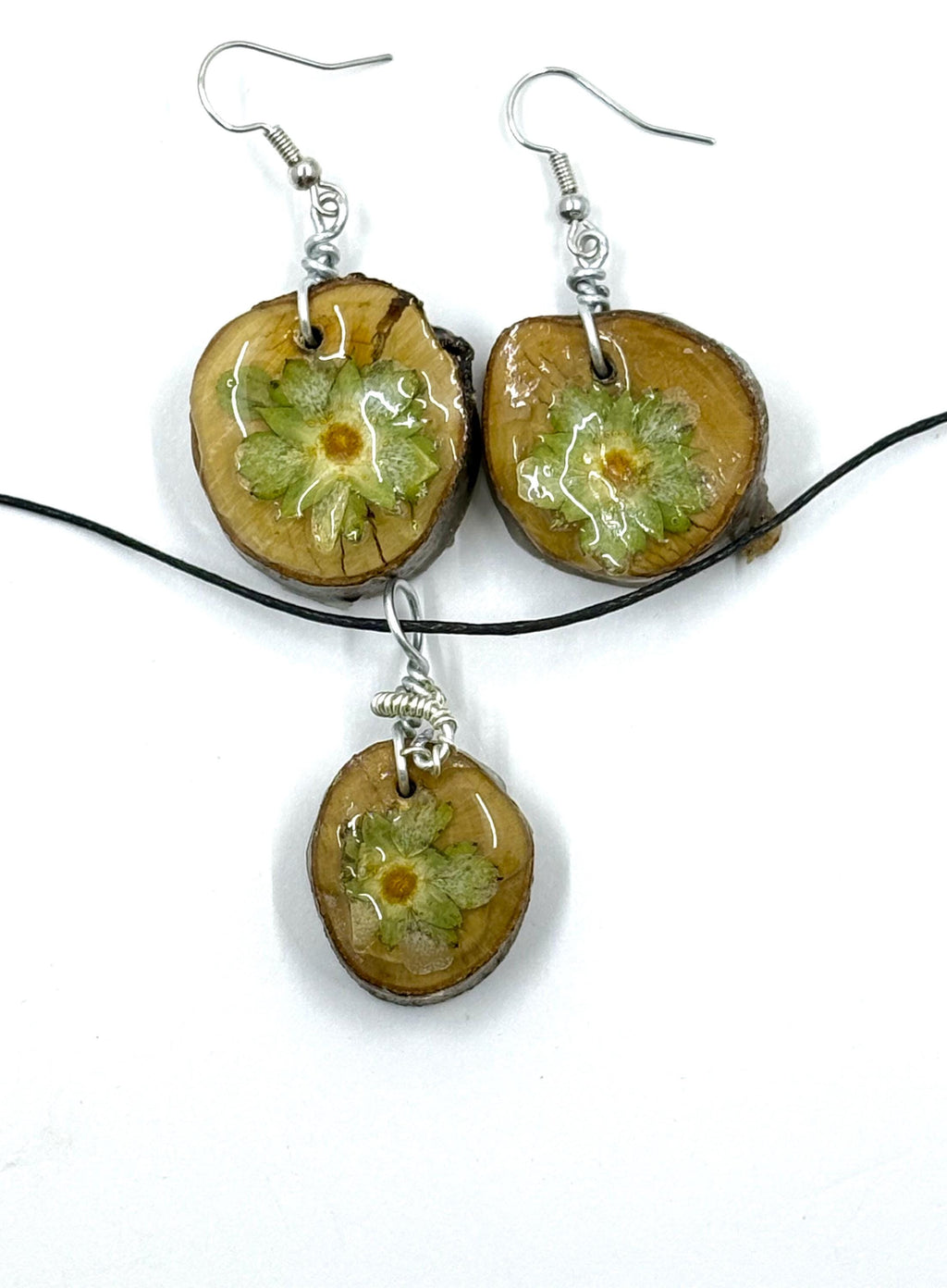 Jewelry set with round pendants and earrings on a white background