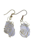 Gold-wire wrapped earrings with gray shell on white background
