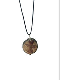 Necklace with a round, brown pendant on a white background
