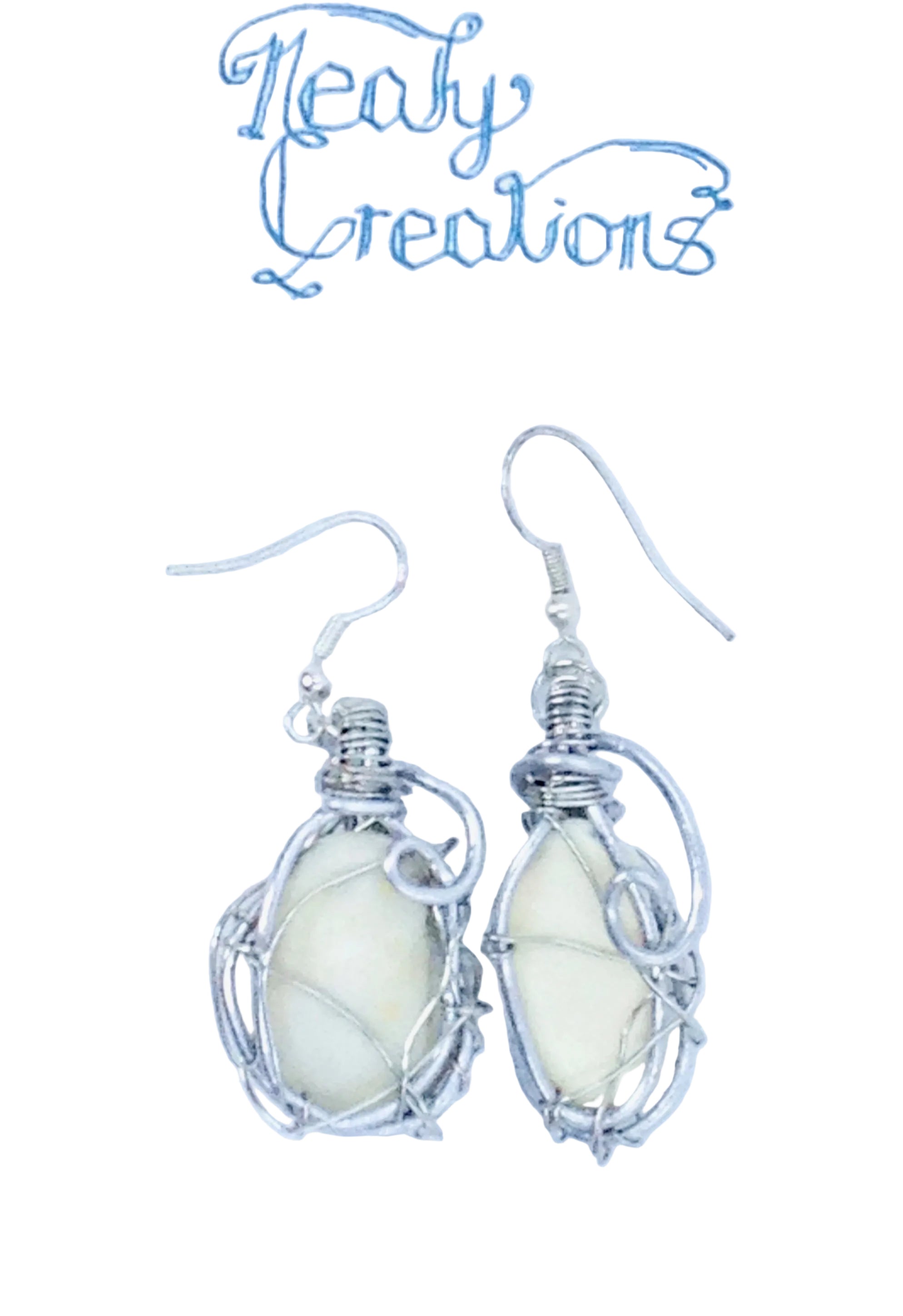 Silver wire-wrapped earrings with white shells on a white background