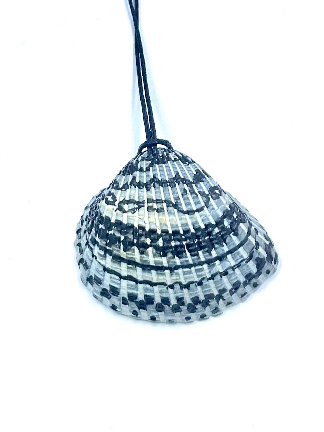 Shell decorated with black and white pattern on a white background