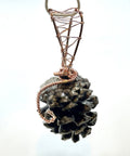 Pine cone pendant with copper wire wrapping on a white background