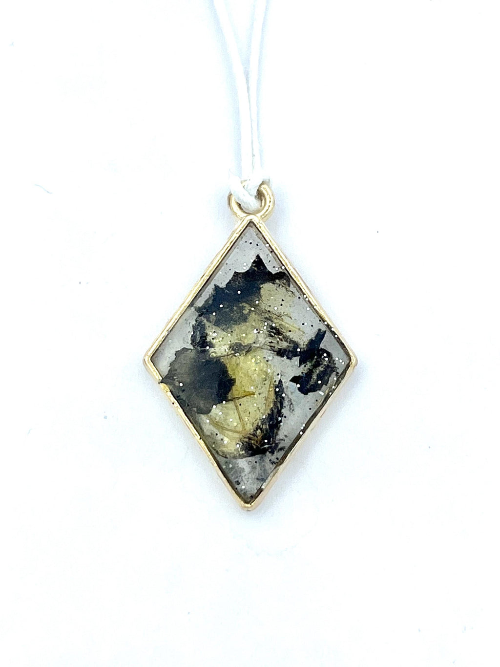 Diamond-shaped pendant with tiger butterfly wings on a white background