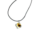 Necklace with a yellow flower pendant on a white background