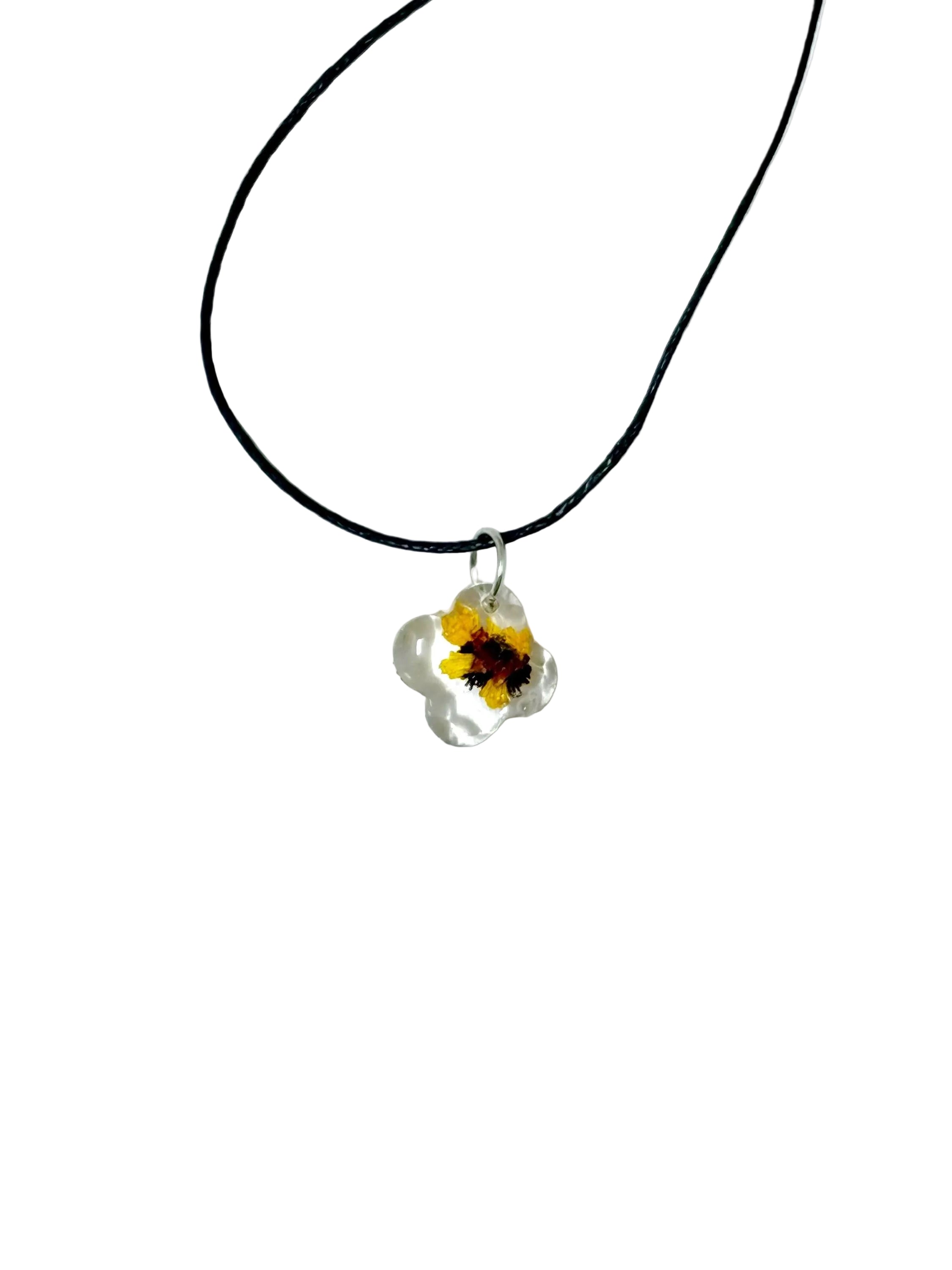 Necklace with a yellow flower pendant on a white background