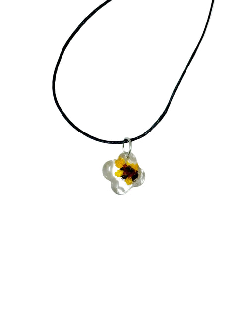 Necklace with a yellow flower pendant on a white background
